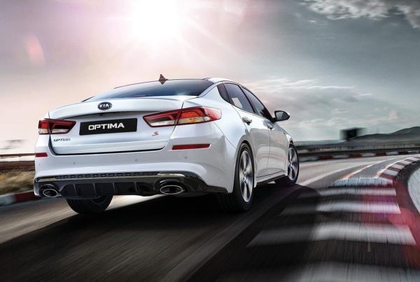 2019-Kia-Optima-S-in-white-racing-down-track